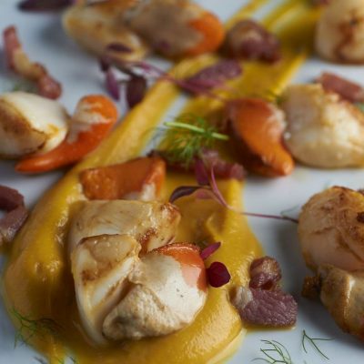 Crab House Cafe - Lyme Bay Scallops, pan fried with bacon, butternut squash puree and red amaranth Crab House Cafe - Lyme Bay Scallops, pan fried with bacon, butternut squash puree and red amaranth